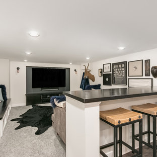 This is an example of a classic fully buried basement in Chicago with white walls, carpet and grey floors.