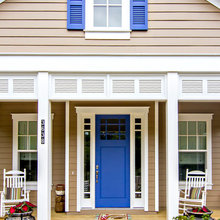 Front door exterior, black metal roof, beige siding