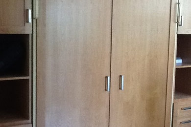 Closet - closet idea in Miami with flat-panel cabinets and light wood cabinets