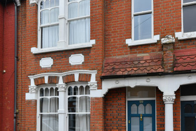 Photo of a classic two floor brick and front terraced house in London.