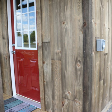 Barn wood siding on a small cabin gives it an especially rustic look