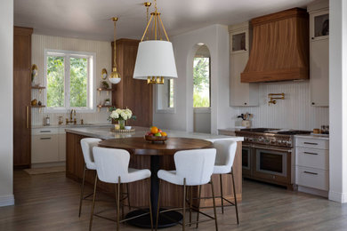 Inspiration for a large transitional l-shaped open concept kitchen remodel in Denver with white backsplash, cement tile backsplash, paneled appliances, an island and beige countertops