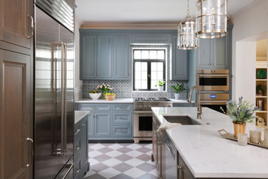 Enclosed kitchen - mid-sized traditional l-shaped porcelain tile and gray floor enclosed kitchen idea in Chicago with an undermount sink, recessed-panel cabinets, gray cabinets, quartz countertops, blue backsplash, marble backsplash, stainless steel appliances, an island and white countertops