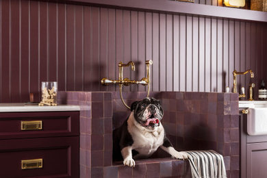 Inspiration for a mid-sized contemporary galley porcelain tile, multicolored floor and shiplap wall utility room remodel in Baltimore with a farmhouse sink, recessed-panel cabinets, dark wood cabinets, quartz countertops, shiplap backsplash, purple walls, a concealed washer/dryer and white countertops