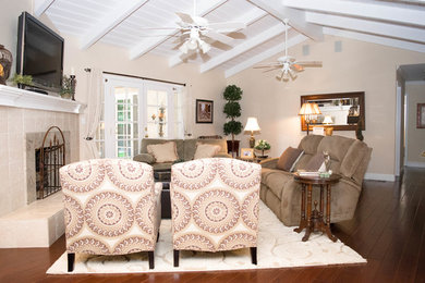 Mid-sized transitional open concept dark wood floor and brown floor living room photo in Sacramento with beige walls, a standard fireplace, a tile fireplace and a wall-mounted tv