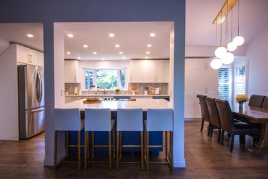 Eat-in kitchen - contemporary dark wood floor and brown floor eat-in kitchen idea in Calgary with a double-bowl sink, gray backsplash, ceramic backsplash, stainless steel appliances, an island and white countertops