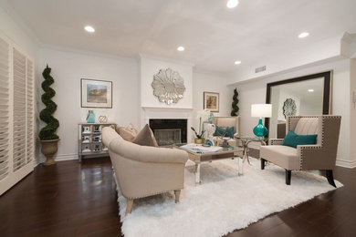 Example of a large transitional enclosed dark wood floor living room design in Los Angeles with a standard fireplace, a wood fireplace surround and no tv