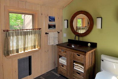 Bathroom - mid-sized craftsman master brown tile and mosaic tile porcelain tile bathroom idea in Manchester with an integrated sink, furniture-like cabinets, medium tone wood cabinets, a one-piece toilet, green walls and copper countertops