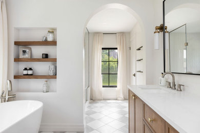 Mid-sized transitional master white tile and subway tile ceramic tile, gray floor and double-sink bathroom photo in Toronto with shaker cabinets, medium tone wood cabinets, a one-piece toilet, white walls, an undermount sink, quartz countertops, a hinged shower door, white countertops and a freestanding vanity