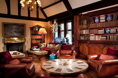 Elegant living room library photo in Other with a standard fireplace