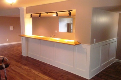 Inspiration for a large modern walk-out medium tone wood floor and brown floor basement remodel in Kansas City with beige walls