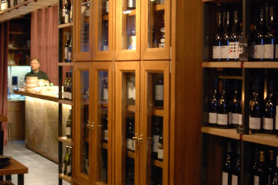 Design ideas for a medium sized contemporary wine cellar in Moscow with ceramic flooring, display racks and grey floors.