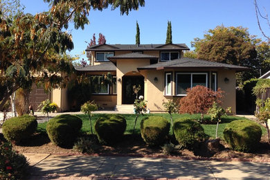 Example of a tuscan beige two-story stucco exterior home design in San Francisco with a hip roof