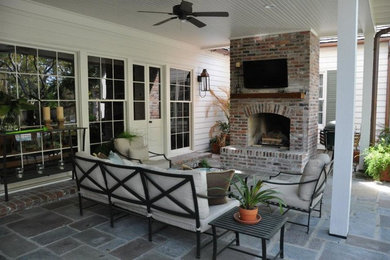 Large elegant backyard tile patio photo in New Orleans with a gazebo and a fire pit