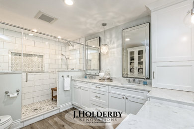 Inspiration for a large contemporary master porcelain tile ceramic tile and multicolored floor double shower remodel in Columbus with recessed-panel cabinets, white cabinets, an undermount sink, quartz countertops and a hinged shower door