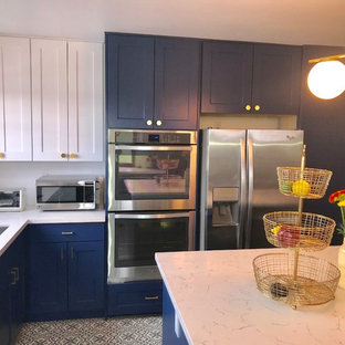 Mid-sized modern u-shaped kitchen pantry in Los Angeles with an undermount sink, shaker cabinets, blue cabinets, quartzite benchtops, stainless steel appliances, porcelain floors, with island and blue floor.