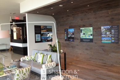 This is an example of an expansive modern entrance in Other with grey walls, light hardwood flooring and grey floors.