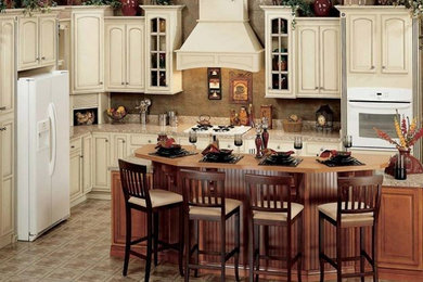 Inspiration for a large timeless l-shaped ceramic tile eat-in kitchen remodel in Miami with raised-panel cabinets, beige cabinets, granite countertops, beige backsplash, white appliances and an island