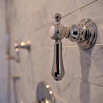 Polished Chrome Shower Controls on Marble Backdrop