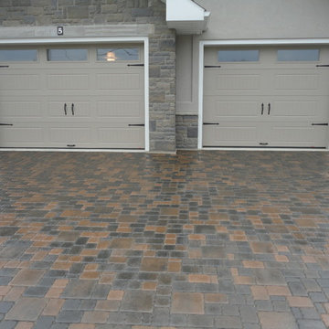 Driveway, front entrance, garden beds, plants, sod.