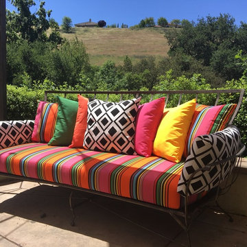 A rainbow of Sunbrella pillows brightens backyard retreat