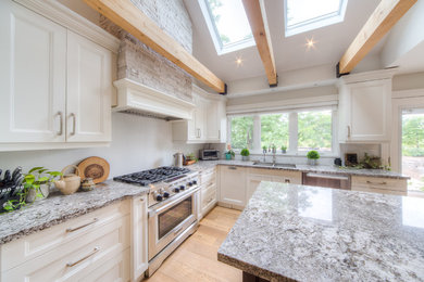 Large transitional l-shaped light wood floor and beige floor enclosed kitchen photo in Toronto with a double-bowl sink, recessed-panel cabinets, white cabinets, granite countertops, stainless steel appliances, an island and gray countertops