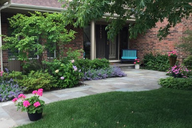 Design ideas for a mid-sized partial sun front yard stone landscaping in Chicago.