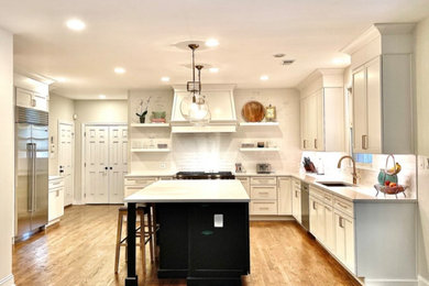 Example of a large medium tone wood floor and brown floor eat-in kitchen design in DC Metro with an undermount sink, shaker cabinets, quartzite countertops, white backsplash, ceramic backsplash, stainless steel appliances, an island and white countertops