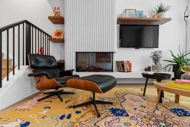 Example of a mid-sized 1950s open concept light wood floor living room design in Toronto with white walls, a two-sided fireplace and a concrete fireplace