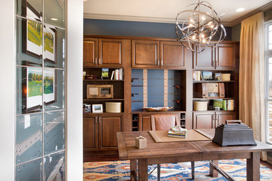 Example of a mid-sized transitional freestanding desk medium tone wood floor study room design in Columbus with blue walls