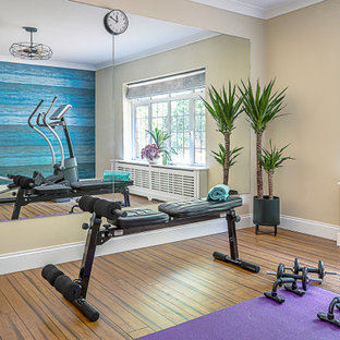 Multifunktionaler, Großer Moderner Fitnessraum mit blauer Wandfarbe, Bambusparkett und braunem Boden in Buckinghamshire