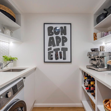 versatile utility space with a walk-in pantry, laundry, and coffee-making area