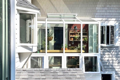 Sunroom - small contemporary slate floor and gray floor sunroom idea in Portland Maine with a glass ceiling