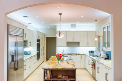 Kitchen - contemporary kitchen idea in Miami with a drop-in sink, flat-panel cabinets, white cabinets, granite countertops, an island, gray backsplash, ceramic backsplash and stainless steel appliances