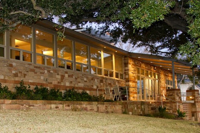 Mid-sized beige one-story stone exterior home photo in Austin