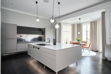 This is an example of a large contemporary grey and white single-wall kitchen/diner in Other with multi-coloured splashback and a feature wall.