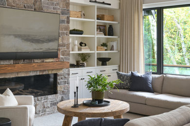 Inspiration for a transitional exposed beam and vaulted ceiling living room remodel in Toronto with beige walls, a ribbon fireplace and a stacked stone fireplace