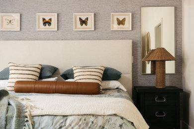 Inspiration for a large transitional medium tone wood floor, brown floor, exposed beam and wallpaper bedroom remodel in Phoenix with gray walls