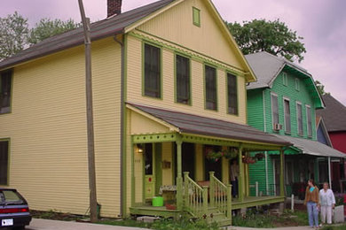 Mid-sized traditional yellow two-story wood gable roof idea in Indianapolis