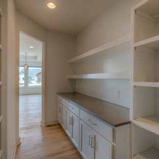 Contemporary kitchen pantry inspiration - Kitchen pantry - contemporary kitchen pantry idea in Omaha with quartzite countertops, white backsplash, subway tile backsplash, stainless steel appliances and an island