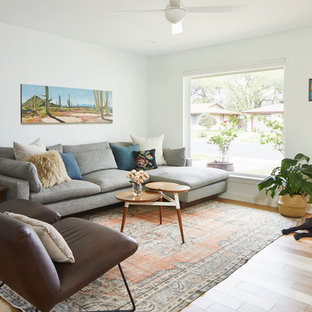 Mid-sized mid-century modern open concept light wood floor and brown floor living room photo in Austin with white walls, no fireplace and a tv stand