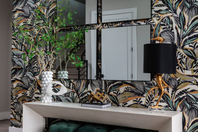 Inspiration for a mid-sized modern medium tone wood floor, beige floor and wallpaper entryway remodel in Houston with a black front door