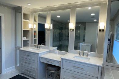 Large transitional master gray tile and porcelain tile ceramic tile, white floor and double-sink walk-in shower photo in Atlanta with shaker cabinets, gray cabinets, white walls, an undermount sink, quartz countertops, a hinged shower door, white countertops, a niche and a built-in vanity
