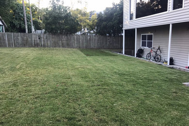 This is an example of a large traditional backyard full sun garden for summer in Brisbane.