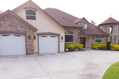 Large arts and crafts brown two-story mixed siding house exterior photo in Seattle with a clipped gable roof and a shingle roof