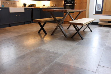 This is an example of a medium sized country kitchen/diner in Other with limestone flooring and grey floors.