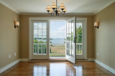 Hallway - craftsman light wood floor hallway idea in Boston with beige walls