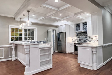 Large transitional galley medium tone wood floor, brown floor and coffered ceiling eat-in kitchen photo in DC Metro with a single-bowl sink, raised-panel cabinets, white cabinets, quartzite countertops, blue backsplash, glass tile backsplash, stainless steel appliances, an island and white countertops