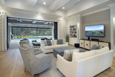 Inspiration for a large contemporary open concept light wood floor and beige floor family room remodel in Miami with gray walls and a wall-mounted tv