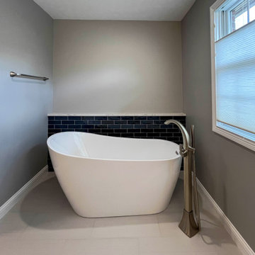 Primary Bathroom with Blue-Gray Vanity and Deep Blue Tiled Feature Wall